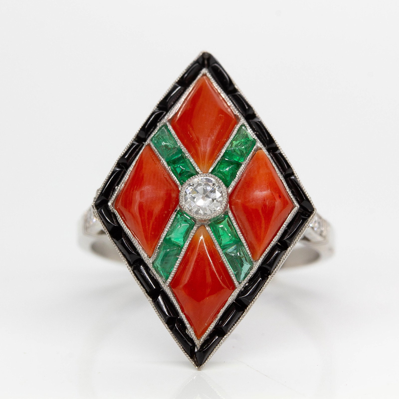 Art Deco Platinum Natural Diamond, Emerald, Onyx and Coral Ring: Title: Art Deco Platinum Natural Diamond, Emerald, Onyx and Coral Ring Description: The Skyler ring is an authentic vintage ring from the Art Deco era Circa 1920. It centers 1 natural old mine cut dia