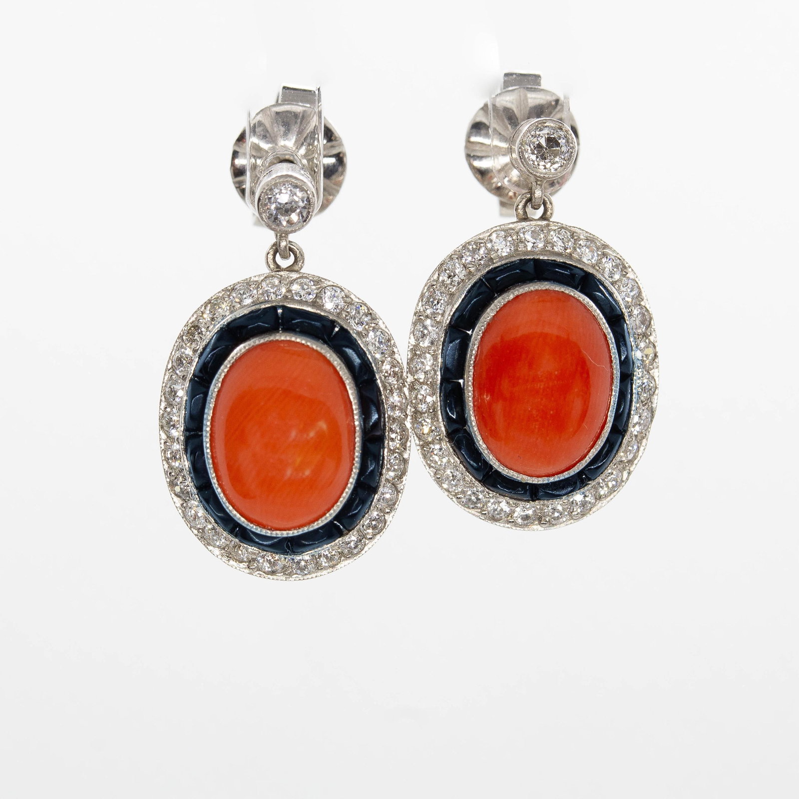 Art Deco Platinum Natural Coral, Onyx and Natural Diamond Earrings: Title: Art Deco Platinum Natural Coral, Onyx and Natural Diamond Earrings Description: The Natasha earrings are a vintage piece from the Art Deco era Circa 1920. They center 2 natural corals surrounde