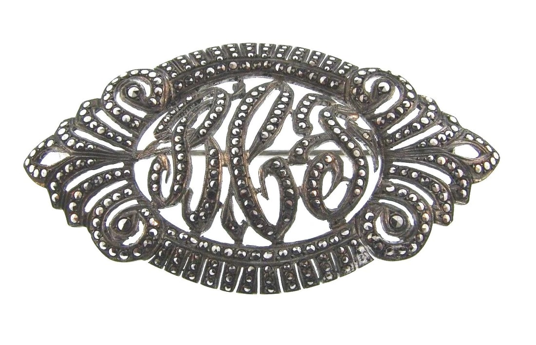 STUNNING Sterling Silver & Marcasite Brooch: Title: STUNNING Sterling Silver & Marcasite Brooch Description: DK Sterling Silver & Marcasite Brooch · Wonderful brooch that is a necessity in your collection. · The weight is 12.7 grams.