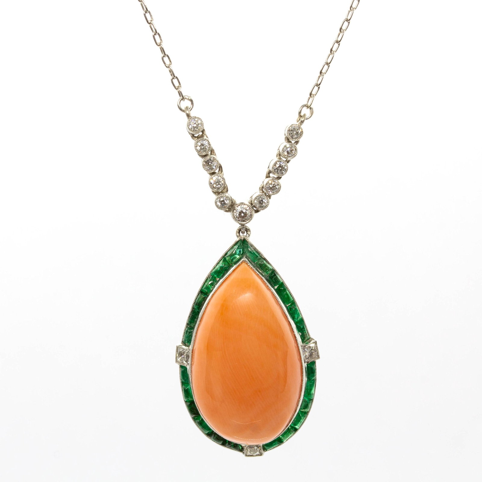 Estate Platinum Natural Coral, Emerald and Natural Diamond Pendant: Title: Estate Platinum Natural Coral, Emerald and Natural Diamond Pendant Description: The Elina pendant is a piece of jewelry handmade in platinum. It centers one natural drop cut coral. This