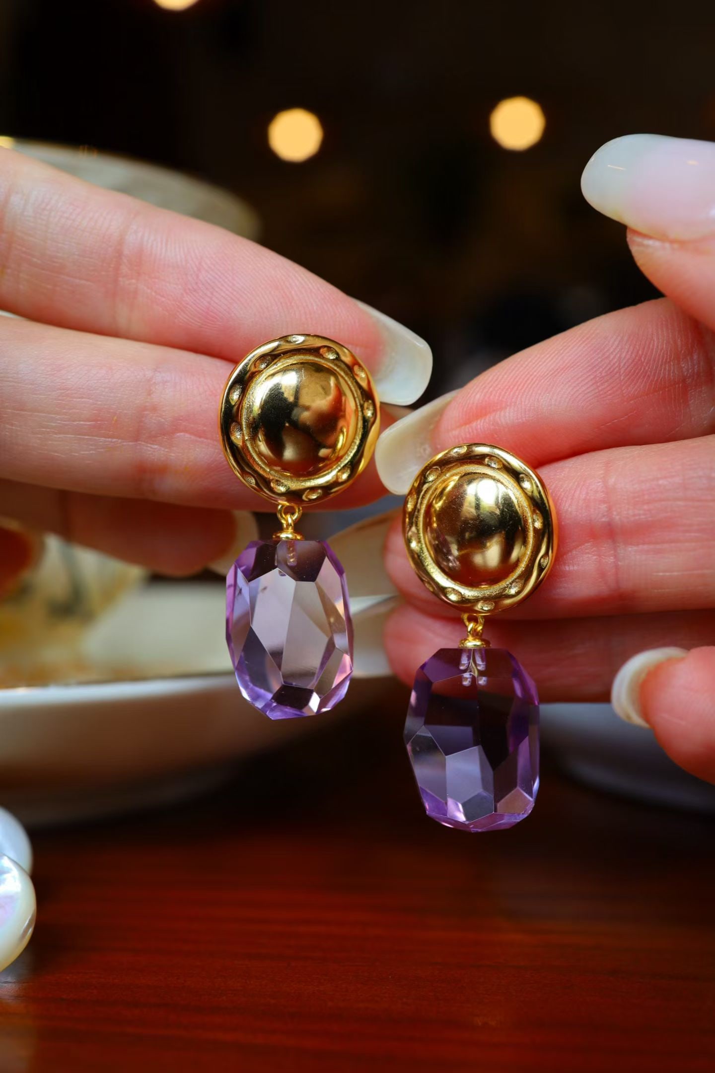Natural Amethyst Earrings: Title: Natural Amethyst Earrings Description: These earrings feature natural amethyst as the main stone, retaining its original freeform shape. Hand-cut to create unique facets, showcasing a vintage c