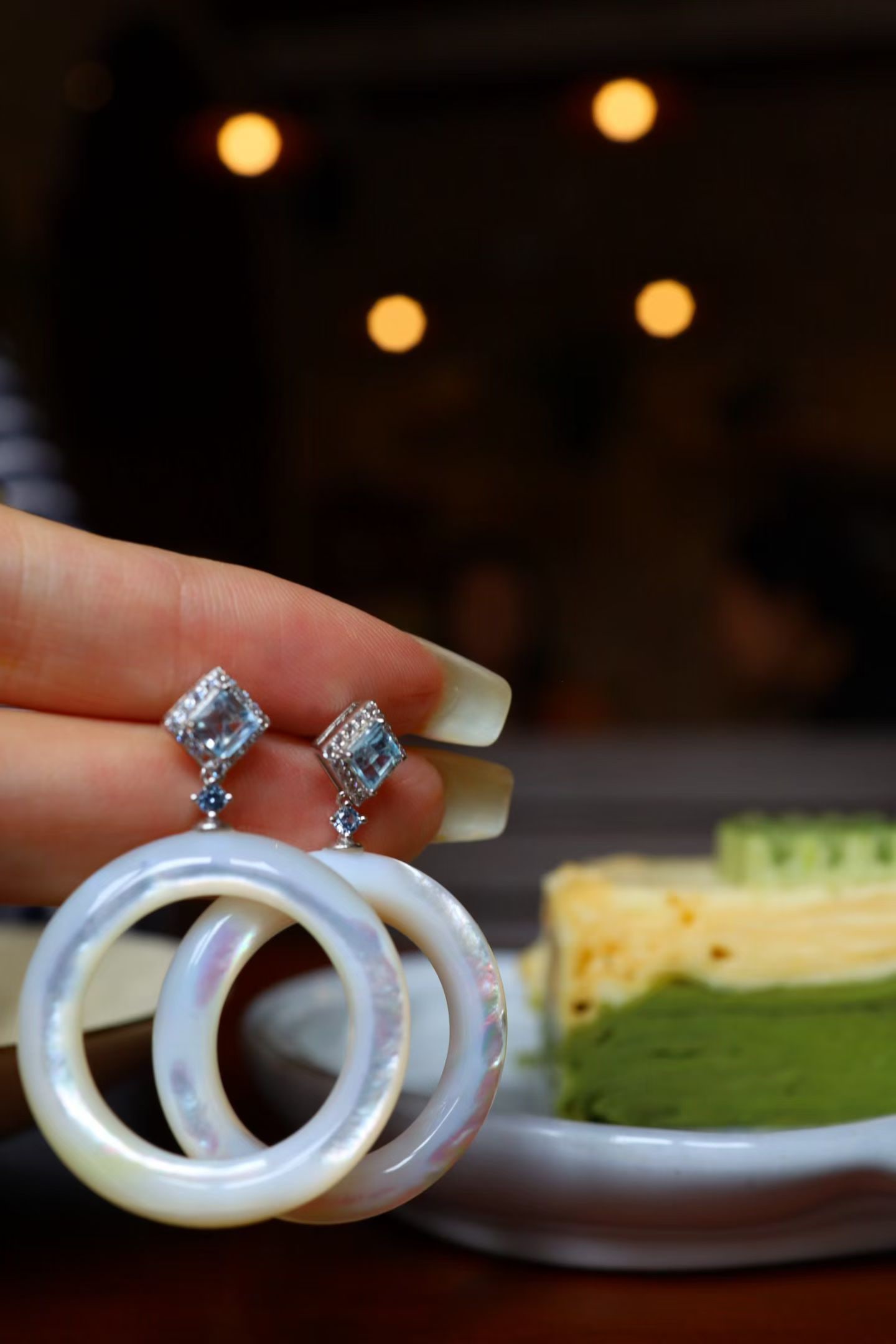 Topaz and White Mother-of-Pearl Earrings: Title: Topaz and White Mother-of-Pearl Earrings Description: Topaz is as transparent as ice water, and white mother-of-pearl emits a soft glow. The large hoop design gently sways as you walk, simple