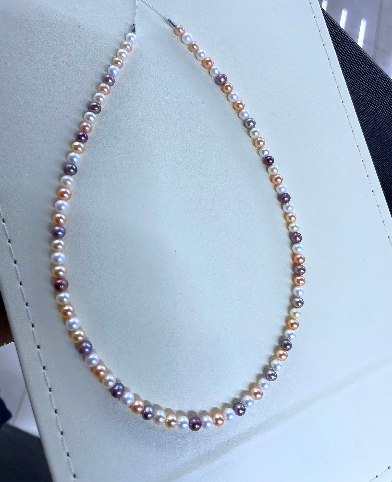 Freshwater Pearl Necklace: Title: Freshwater Pearl Necklace Description: This necklace features freshwater pearls with a mix of colorful luster, showcasing unique charm. The pearls have strong luster, are nearly round with slig