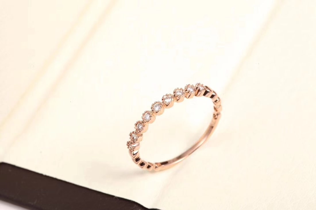 18K Gold Diamond Band Ring: Title: 18K Gold Diamond Band Ring Description: This 18K gold diamond band ring features a simple yet luxurious design. The exquisite diamonds set on the ring emit a brilliant sparkle. Suitable for var