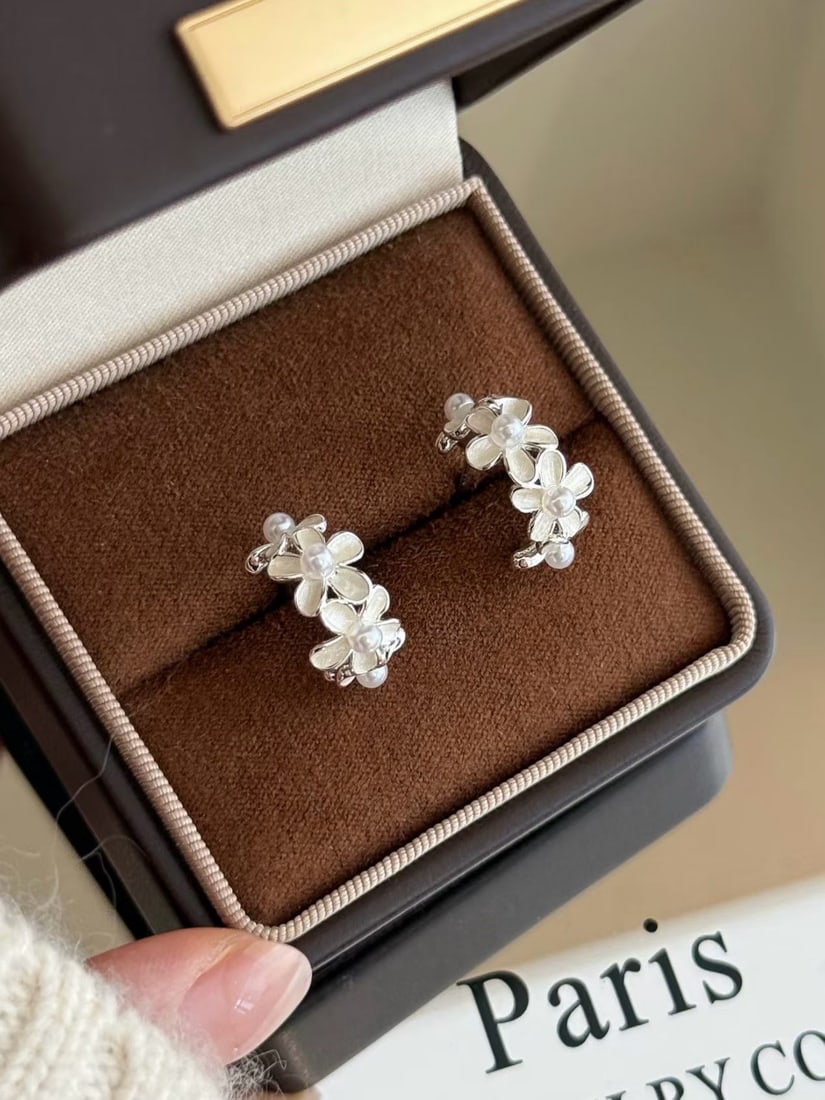 Natural Freshwater Flawless Pearl Earrings: Title: Natural Freshwater Flawless Pearl Earrings Description: These earrings feature a gentle floral cluster design, with each petal centered by a pearl. They shimmer with delicate light upon slight