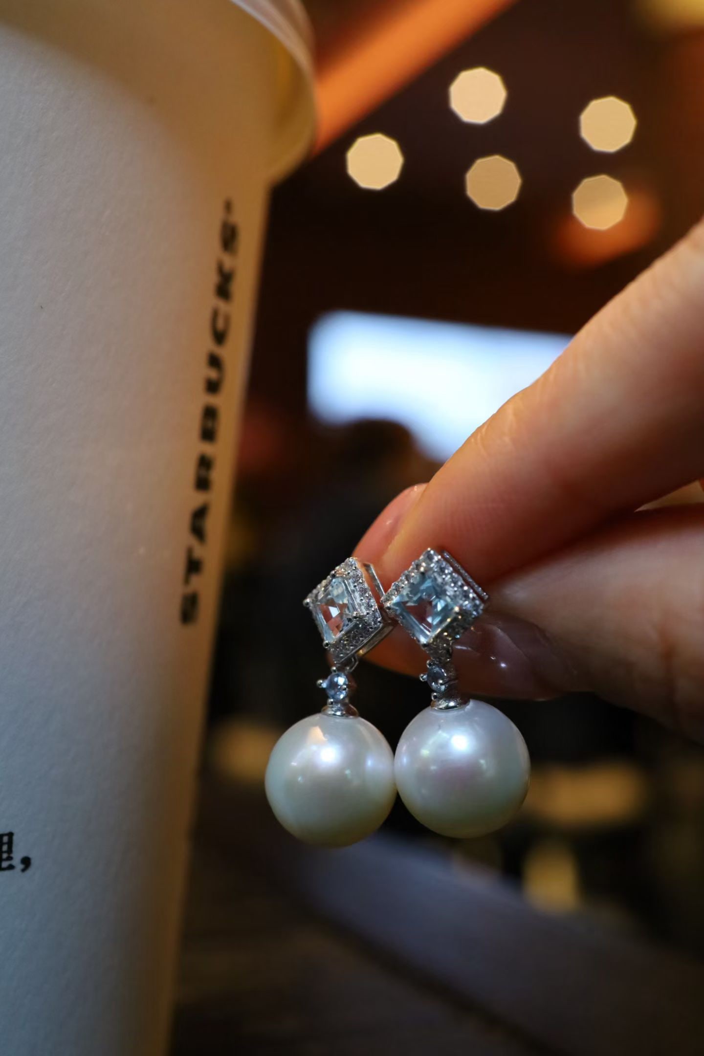 Topaz Pearl Earrings: Title: Topaz Pearl Earrings Description: These earrings perfectly combine topaz and pearls, showcasing a simple yet elegant style. The luster of the pearls complements the transparency of the topaz,