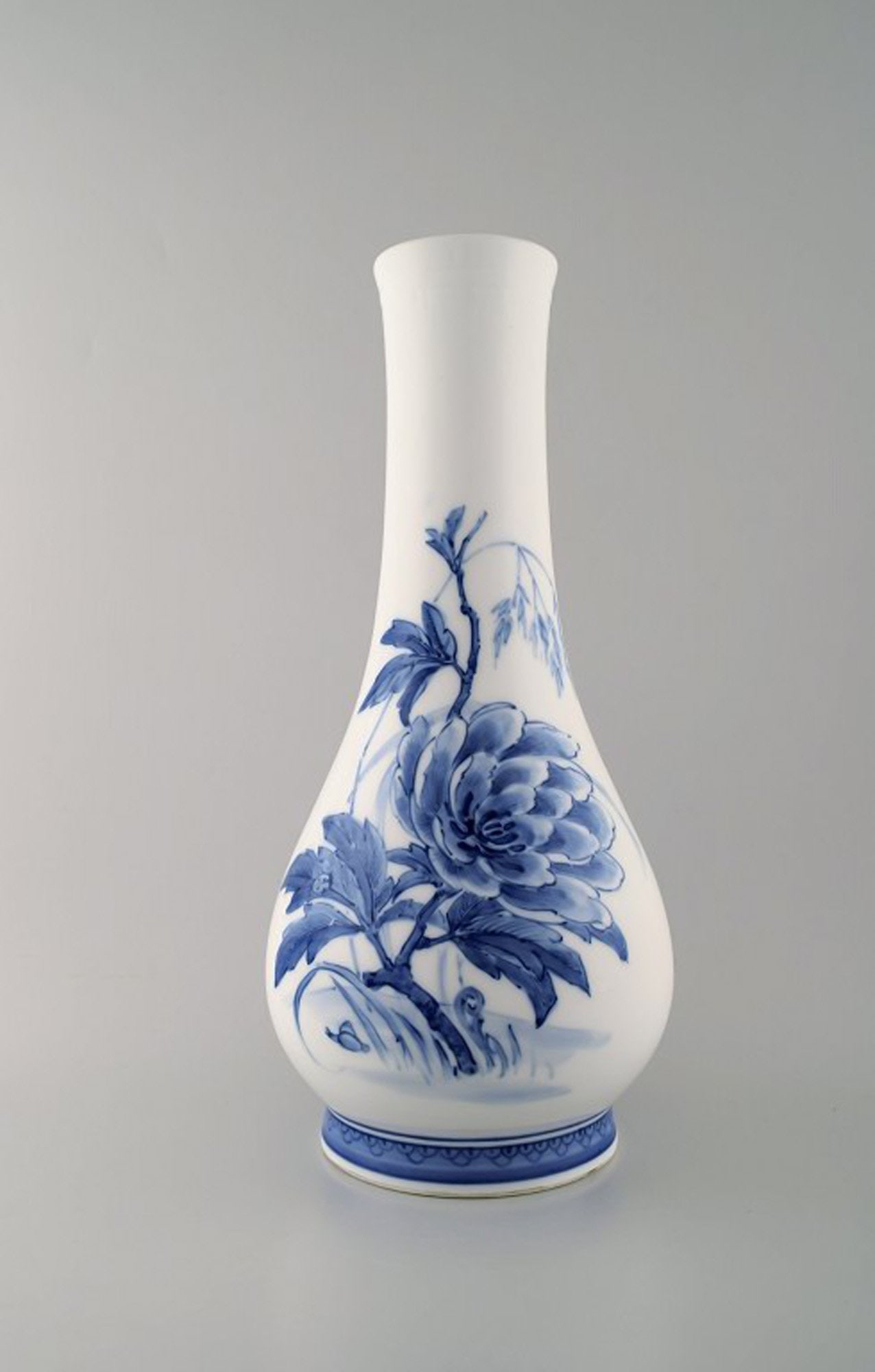 Oluf Jensen for Royal Copenhagen. Large unique porcelain vase with slim neck. Hand-painted with: Title: Oluf Jensen for Royal Copenhagen. Large unique porcelain vase with slim neck. Hand-painted with flowers. 1921. Description: Oluf Jensen for Royal Copenhagen. Large unique porcelain vase with sl