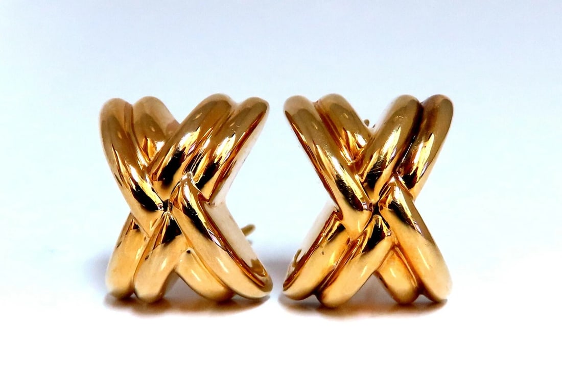 14kt Gold Raised X Clip Earrings**: Title: 14kt Gold Raised X Clip Earrings** Description: Smooth Classic X Clip Earrings Measurements of Earrings: .8 x .71 Inch Depth: .35inch Comfortable Omega Clips 7.9 grams / 14kt. Yellow Gold