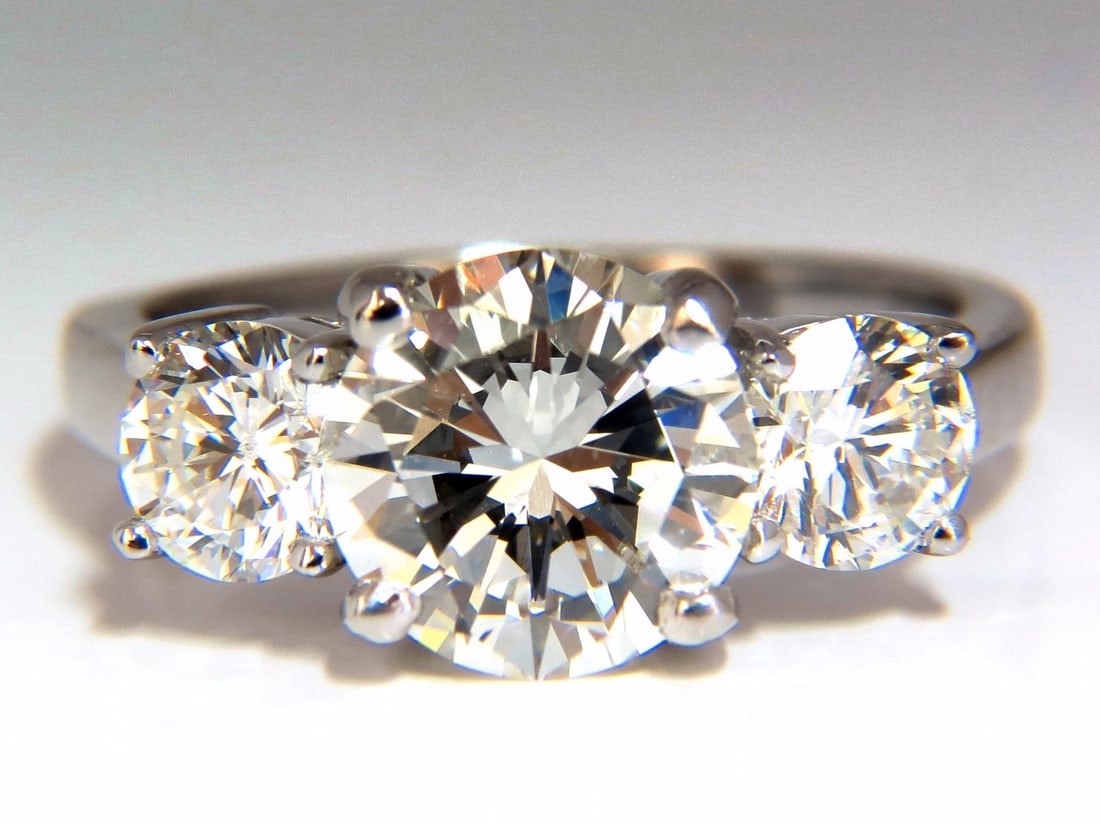 GIA CERTIFIED 4.41CT NATURAL ROUND BRILLIANT DIAMOND RING CLASSIC THREE *v: Title: GIA CERTIFIED 4.41CT NATURAL ROUND BRILLIANT DIAMOND RING CLASSIC THREE *v Description: GIA certified, Classic Three 3.01ct. Center Round Brilliant diamond. GIA Report: 2155730907 J-color Vs-1 