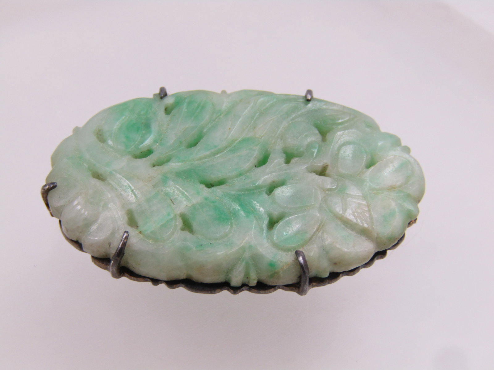 Antique Sterling Carved Jade Floral Brooch, 1920's: Title:Antique Sterling Carved Jade Floral Brooch, 1920's Description:Antique Sterling Carved Jade Floral Brooch, 1920's. This is an oval that is appx. 1-5/8" by 7/8" wide with five prong, locking