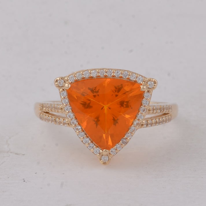2.18 Ct Trillion Br.Fire Opal 9K Gold Ring: 2.18 Total Carat Br.Fire Opal 9K Gold Ring Specifications: Total Weight 2.508 g Center Gemstone Br.Fire Opal Gemstone Carat Weight 1.9 Carats Gemstone Measurements 9.80X9.80X6.30 mm Additional Gemston