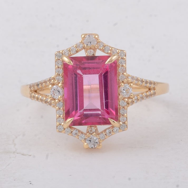 3.22 Ct Octagon Pink Topaz 9K Gold Ring: 3.22 Total Carat Pink Topaz 9K Gold Ring Specifications: Total Weight 2.76 g Center Gemstone Pink Topaz Gemstone Carat Weight 2.86 Carats Gemstone Measurements 9X7 mm Additional Gemstones White Sapphi