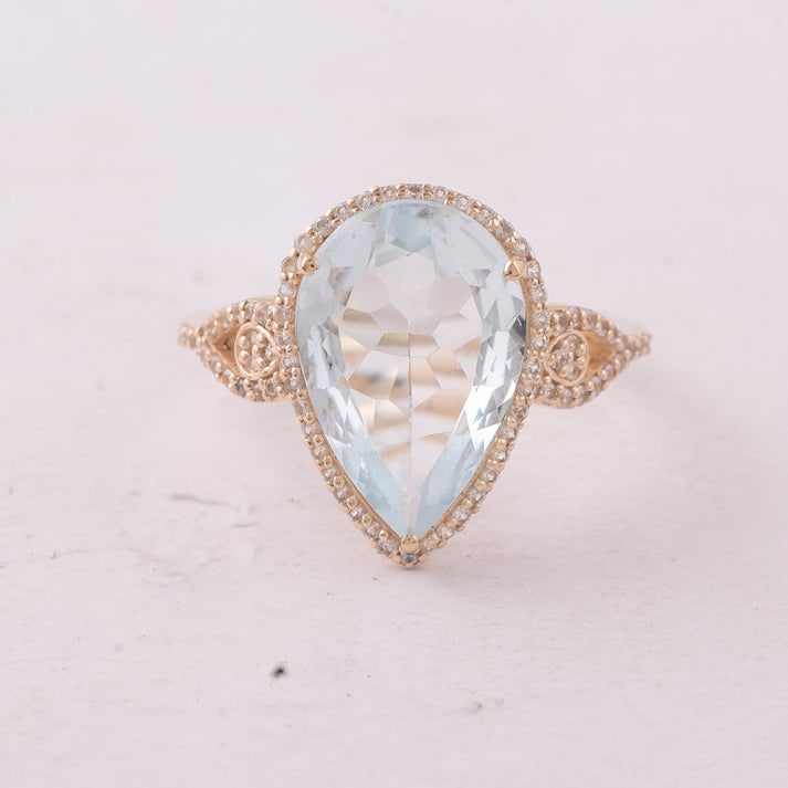 4.05 Ct Pear Aquamarine 9K Gold Ring: 4.05 Total Carat Aquamarine 9K Gold Ring Specifications: Total Weight 2.719 g Center Gemstone Aquamarine Gemstone Carat Weight 3.73 Carats Gemstone Measurements 15X10 mm Additional Gemstones White Sap