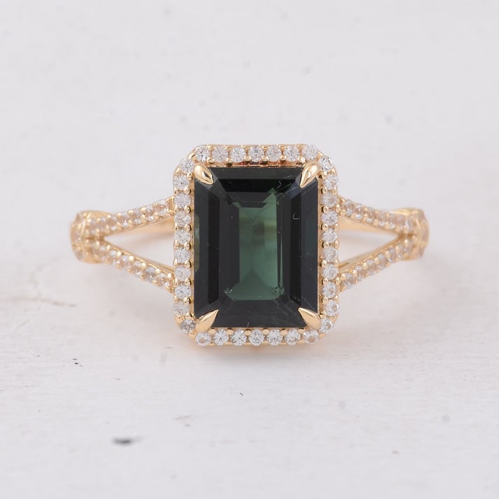 2.91 Ct Octagon Tourmaline 9K Gold Ring: 2.91 Total Carat Tourmaline 9K Gold Ring Specifications: Total Weight 2.401 g Center Gemstone Tourmaline Gemstone Carat Weight 2.59 Carats Gemstone Measurements 9X7X4.70 mm Additional Gemstones White 