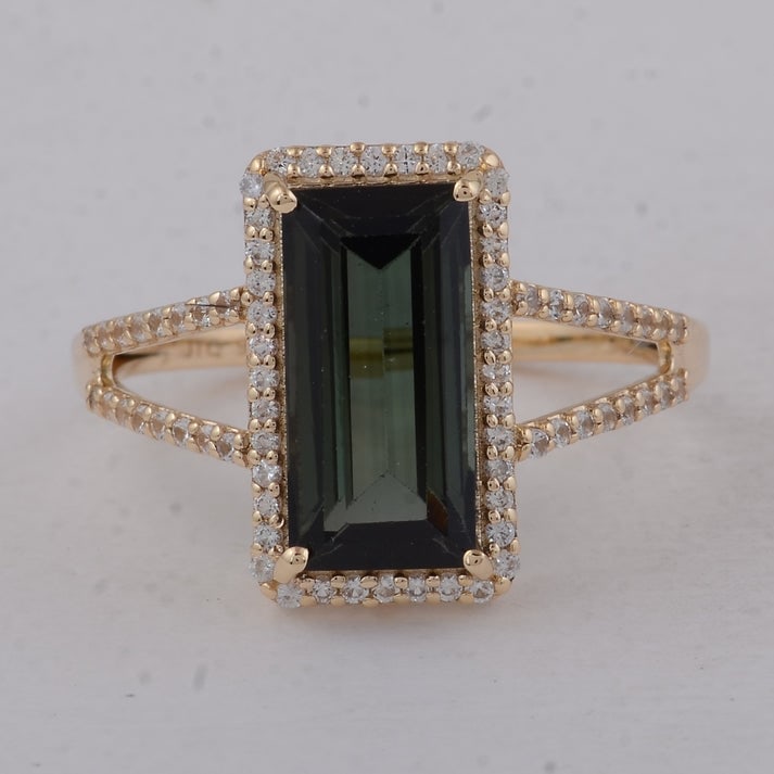 3.13 Ct Baguette Tourmaline 9K Gold Ring: 3.13 Total Carat Tourmaline 9K Gold Ring Specifications: Total Weight 2.5 g Center Gemstone Tourmaline Gemstone Carat Weight 2.81 Carats Gemstone Measurements 12X6X4.40 mm Additional Gemstones White S