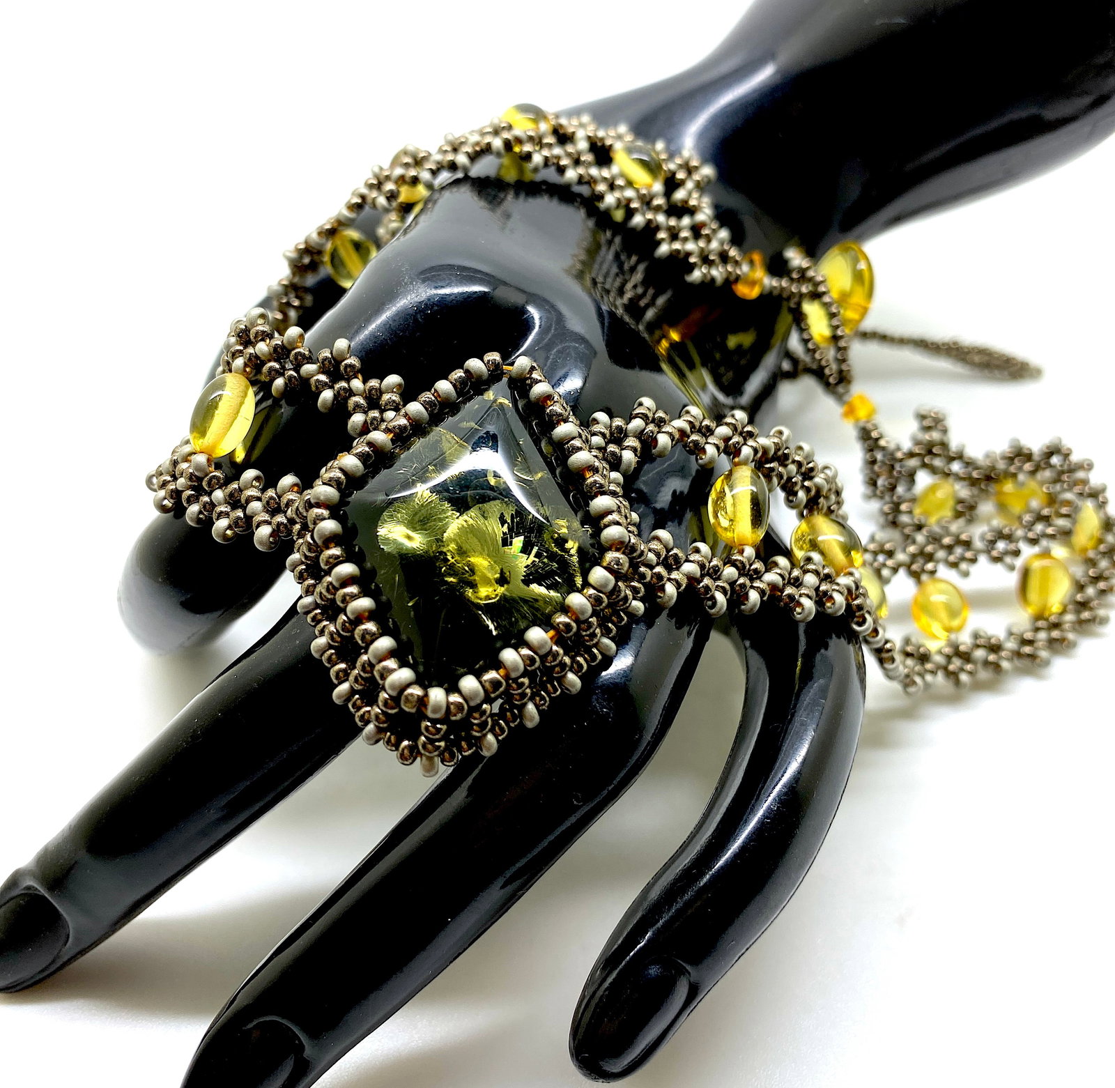 Antique Amber Floral Choker made from leaf like bead ornaments: Title: Antique Amber Floral Choker made from leaf like bead ornaments Metal: None Gemstone: Amber Weight: 19.3 g Size: Size: 380.0 x 10.0 x 30.0 mm Size: 14.961 x 0.394 x 1.181 inches Made of: (Recons