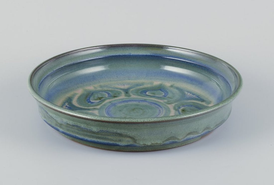 Danish ceramicist. Large ceramic bowl. Ca. 1970s.: Danish ceramicist. Large ceramic bowl. One of a kind. Hand-glazed. Glaze in blue and green tones. Dating: Ca. 1970s. Indistinct artist signature and Denmark In perfect condition. Dimensions: D 30.0 cm