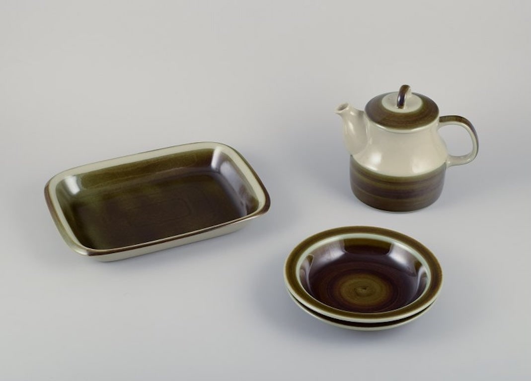 Marianne Westman for Rorstrand, Sweden. Four pieces of 'Maya' stoneware. A teapot, two deep plates, (1 of 7)