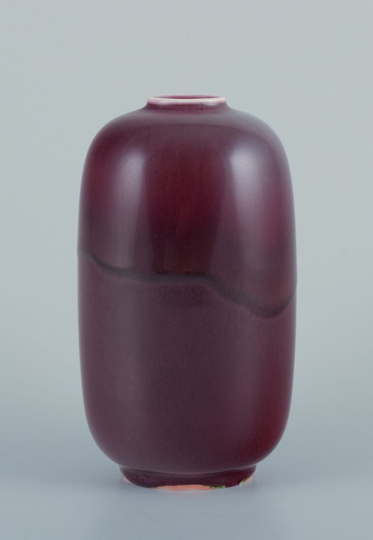 Nils Thorsson for Royal Copenhagen. Large ceramic vase with ox-blood glaze. Mid-20th C.: Nils Thorsson for Royal Copenhagen. Large unique ceramic vase. Oval shape. Ox-blood glaze. Mid-20th century. Perfect condition. First factory quality. Marked. Dimensions: Height 18.0 cm x 10.0 cm. Pro