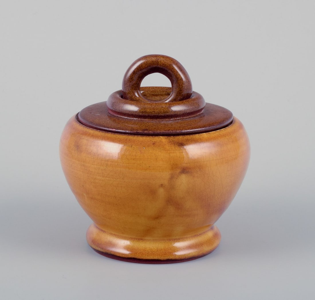 Suzanne Ramie for Atelier Madoura, France. Unique ceramic lidded jar. Mid-20th C.: Suzanne Ramie (1905-1974) for Atelier Madoura, France. Unique ceramic lidded jar. Uranium yellow glaze. Mid-20th century. In excellent condition with natural craquelure. Dimensions: Diameter 12.0 cm x