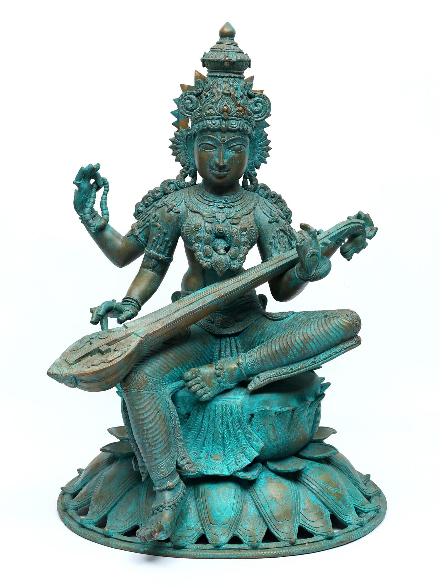 24" Four Armed Goddess Saraswati Seated on Lotus | Bronze Statue: Title: 24" Four Armed Goddess Saraswati Seated on Lotus | Bronze Statue Additional Information: itemcode: DDO072 Reserve: $3,622.00 Shipping: Domestic: Shipping rates are determined by destination Int
