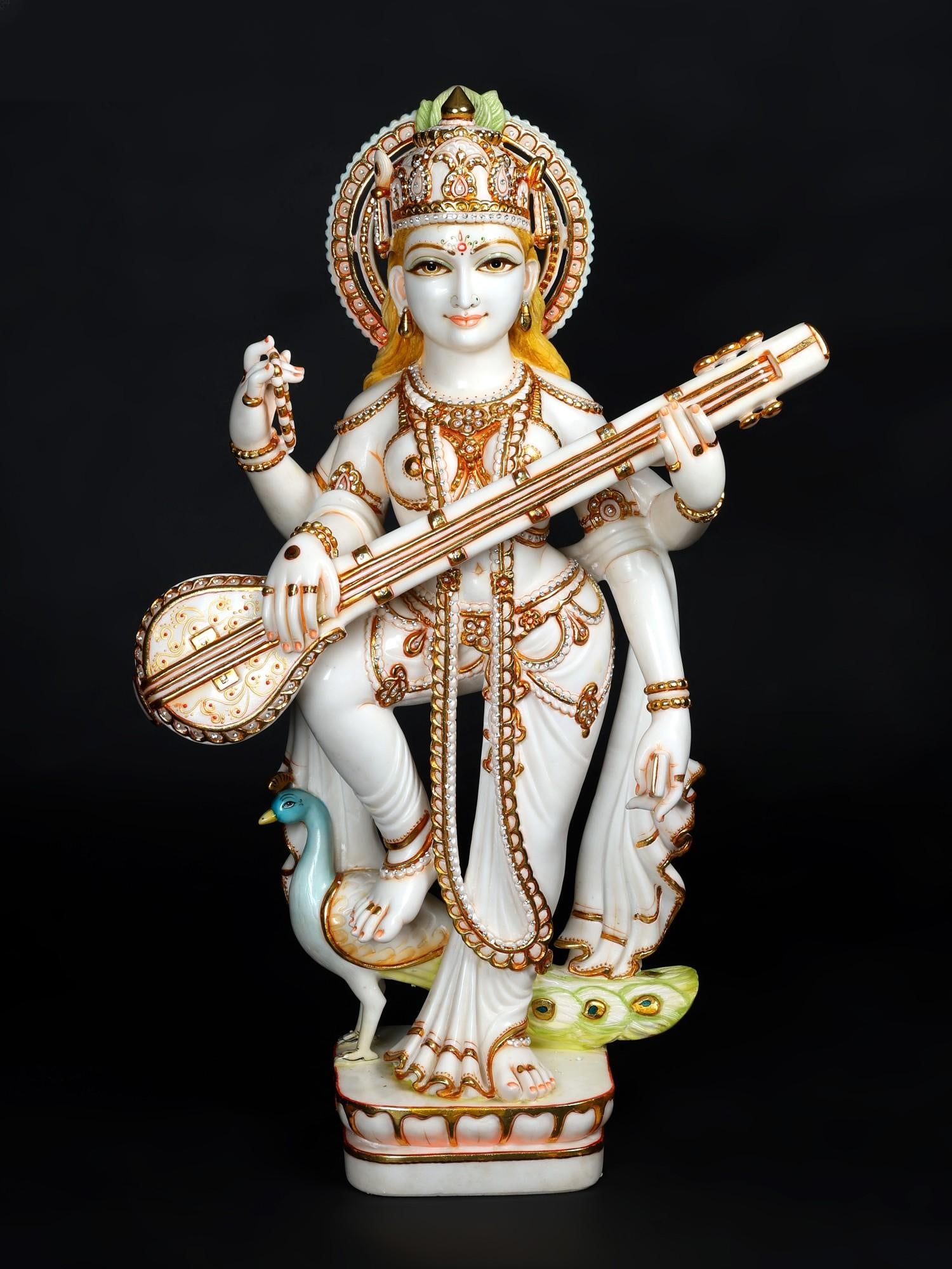 36" Large Standing Goddess Saraswati Playing Veena | White Marble Statue: Title: 36" Large Standing Goddess Saraswati Playing Veena | White Marble Statue Additional Information: itemcode: DDO211 Reserve: $5,170.00 Shipping: Domestic: Shipping rates are determined by destina