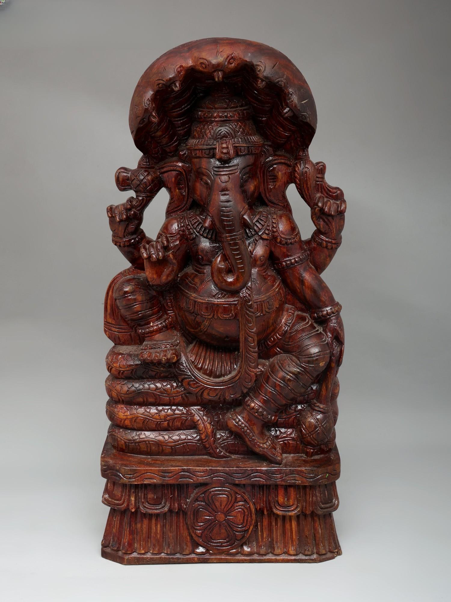 24" Lord Ganesha Seated on Naag | Wood Carving: Title: 24" Lord Ganesha Seated on Naag | Wood Carving Additional Information: itemcode: DDO673 Reserve: $616.00 Shipping: Domestic: Shipping rates are determined by destination International: Foreign