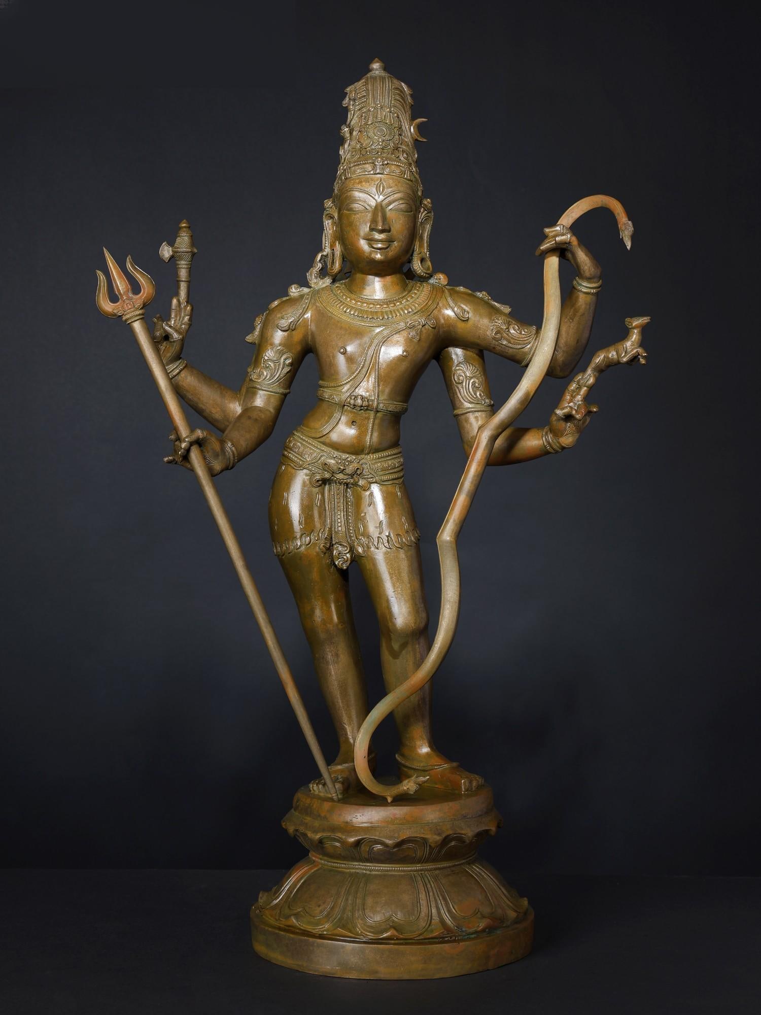 Superfine Pinaka-Dhara Shiva Bronze Statue: Description: In the Shiva Panchakshara Stotram, Mahadeva appears as a heavenly and powerful Yaksha, who keeps his hair in a matted updo, carries the Pinaka bow, the eternal god, and is represented by