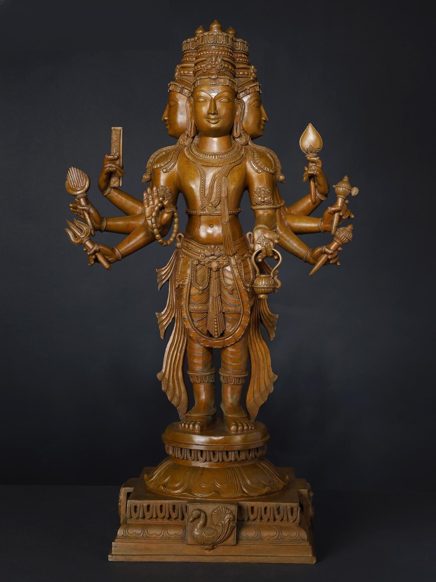24" Superfine Standing Lord Brahma Bronze Statue: Description: Veda’s most powerful divine being remembered as "Hiranyagarbha" (he who is and is born from the golden womb)- Bhagwan Brahma in this immaculate bronze statue is represented as described