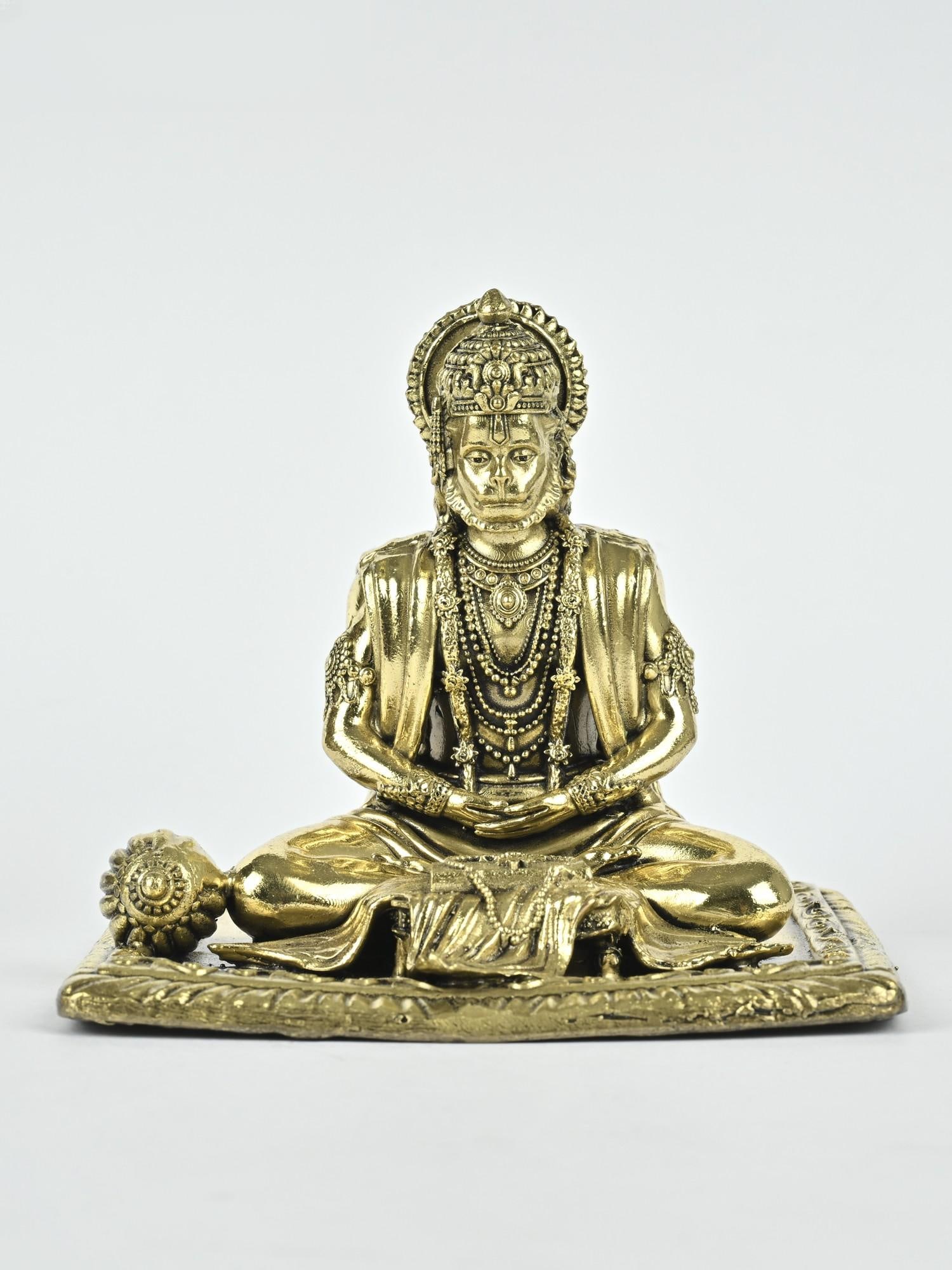 Small Superfine Shri Ram Bhakt Hanuman Brass Statue: Description: Kindness, devotion, and divinity find home in this ornate icon of Shri Ram Bhakt Hanuman. In Dhyana mudra with eyes lowered in a meditative gaze, Hanuman is adorned with crown, necklaces,