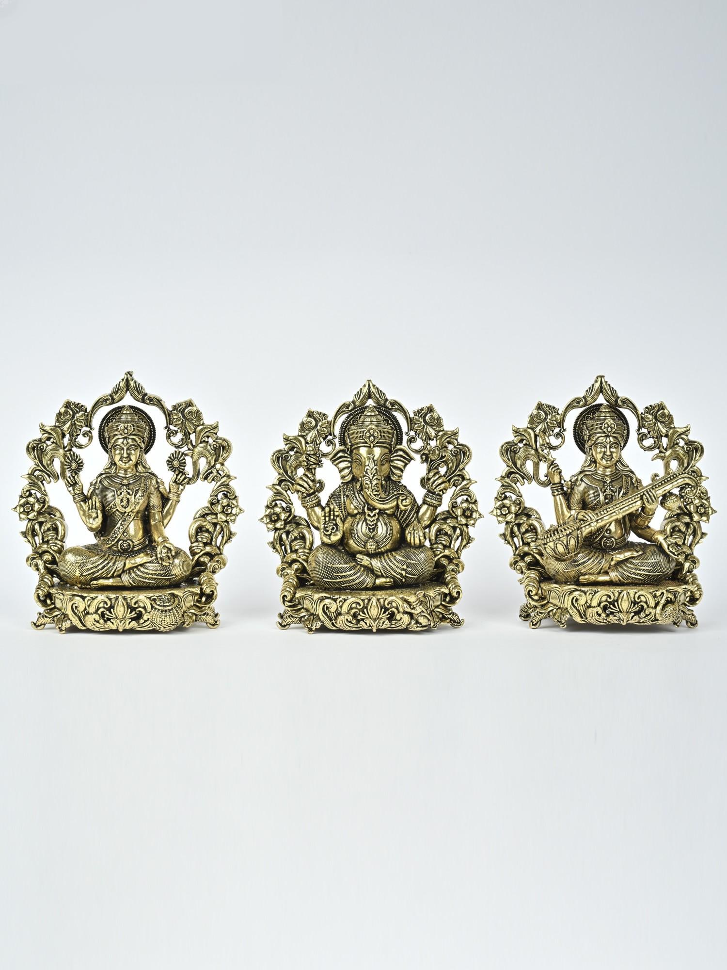 4" Small Superfine Lakshmi Ganesha Saraswati Brass Statues with Floral Prabhavali: Description: Magnificent in detail, these superfine brass icons of Lakshmi-Ganesha-Saraswati are iconographically the most complete and auspicious composition of the three deities. Each icon is perfec