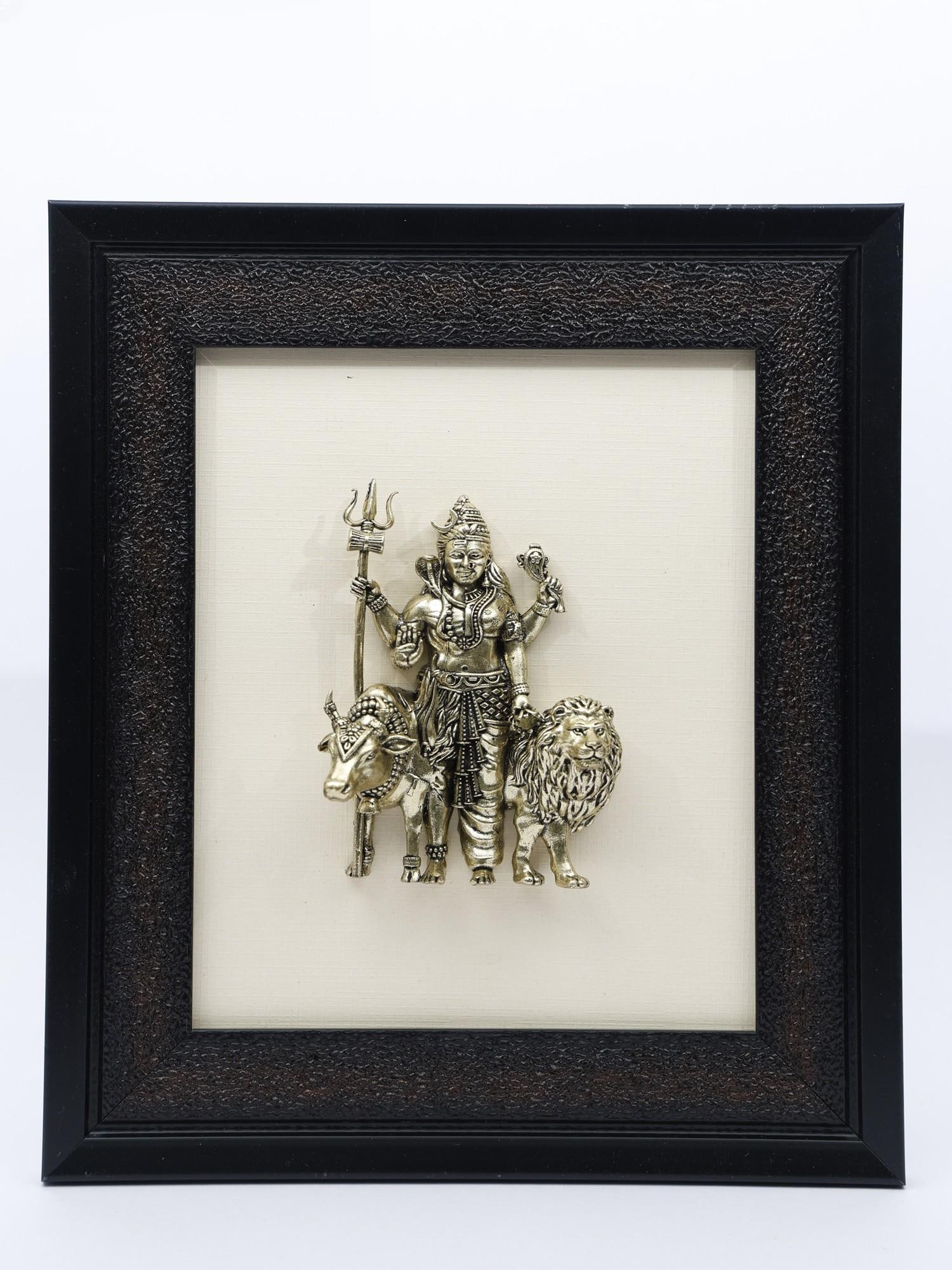 9" Superfine Ardhanarishvara with Nandi and Lion /Wall Hanging Framed Brass Statue: Description: Ardhanarishwara Roopa of Shiva-Parvati is the most auspicious image in the three realms. The embodiment of a balance of contrasting virtues, Ardhanarishwara appears at the heart of this