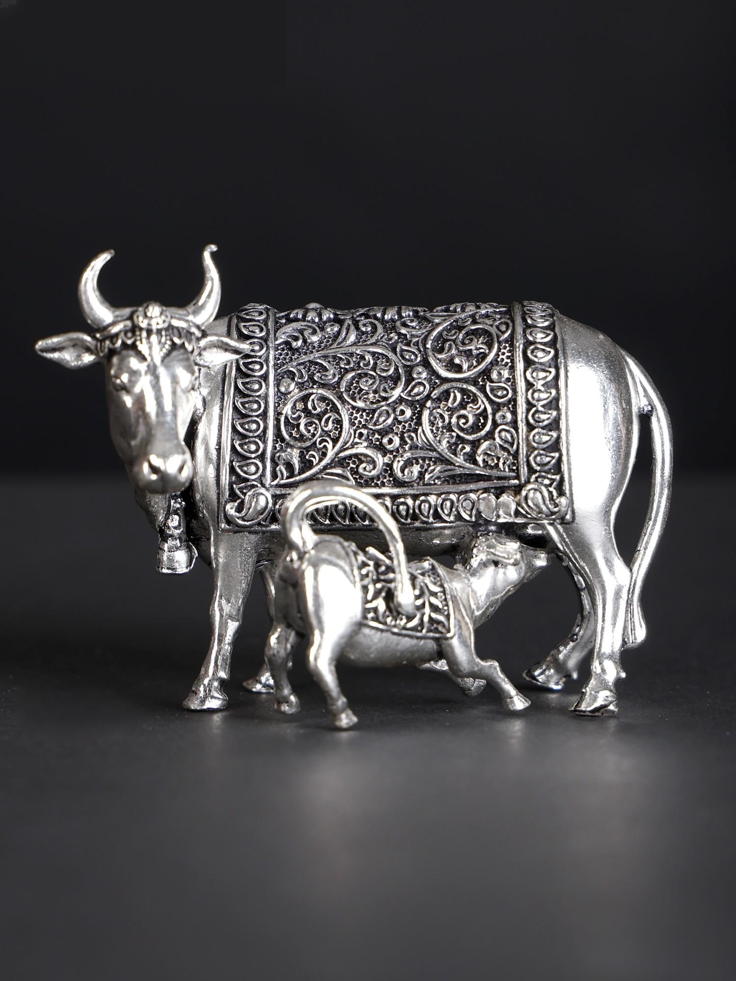 Small Superfine Cow and Calf /Silver Plated Brass Statue (Multiple Sizes): Description: The cow and calf image, also Kamadhenu with calf is a powerful icon according to Vaastu principles. A symbol of Lakshmi herself, and abode of all gods and goddesses, the Kamadhenu cow is