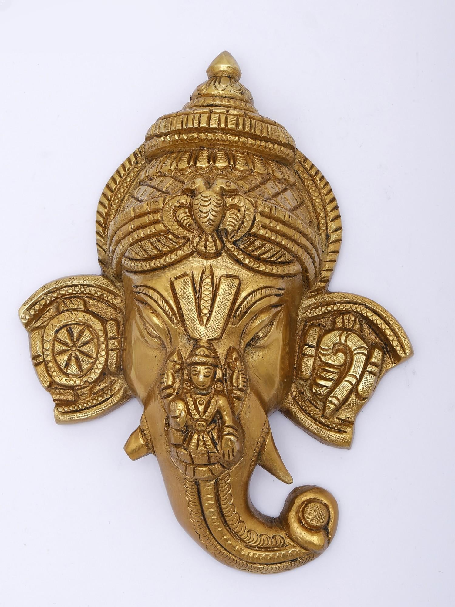 Ganesha Brass Wall Hanging with Lakshmi, Gandabherunda, Shankha, and Chakra Symbols: Description: Ancient and auspicious symbols of Hinduism combine in this unique wall hanging. Ganesha as the sacred, first-revered one forms the space, inhabited by the goddess of wealth, Maa Lakshmi s
