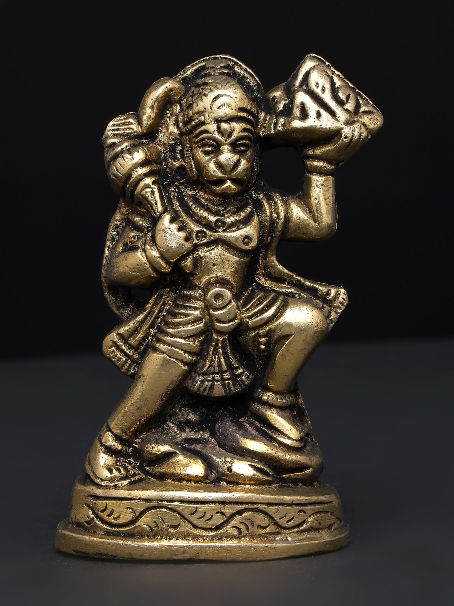 Lord Hanuman Carrying Sanjeevani /Small Brass Statue: Description: Lord Hanuman carrying Dronagiri mount with the Sanjeevani is a powerful vision of his benevolent and mighty persona, always ready to salvage those who evoke him. This small brass statue