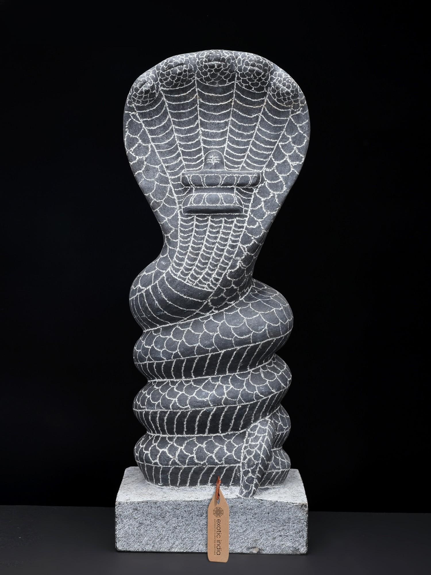 15" Five Headed Snake Hand Carved Granite Stone Statue: Description: The supremely powerful image of the ancient Lord Shiva lies at the heart of the exquisitely coiled granite snake or Naga, which symbolizes the awakening of Kundalini, or inner intelligenc