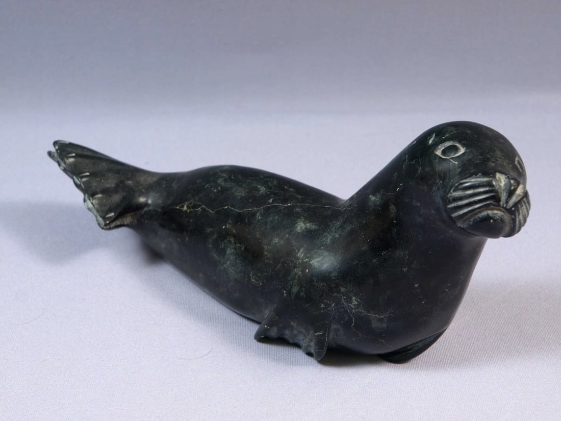 Inuit Canada Carving Native Seal Soapstone SIGNED Vintage Eskimo sticker: This is a vintage Native American Eskimo Inuit Figurine. It is signed on the bottom by the artist with symbols and numbers. It is is made in 1976. It retains an original Canada Eskimo Art Sticker. The