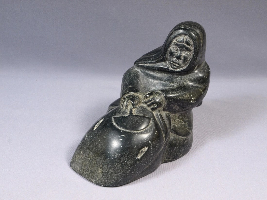 Signed Inuit Native American Soapstone Woman with Ulu Signed Canada VINTAGE 1976: This is a vintage Primitive Native American Eskimo Inuit Figurine. It is signed at the bottom with syllables. It looks like it was made in 1976. The figurine is made from soapstone and is very