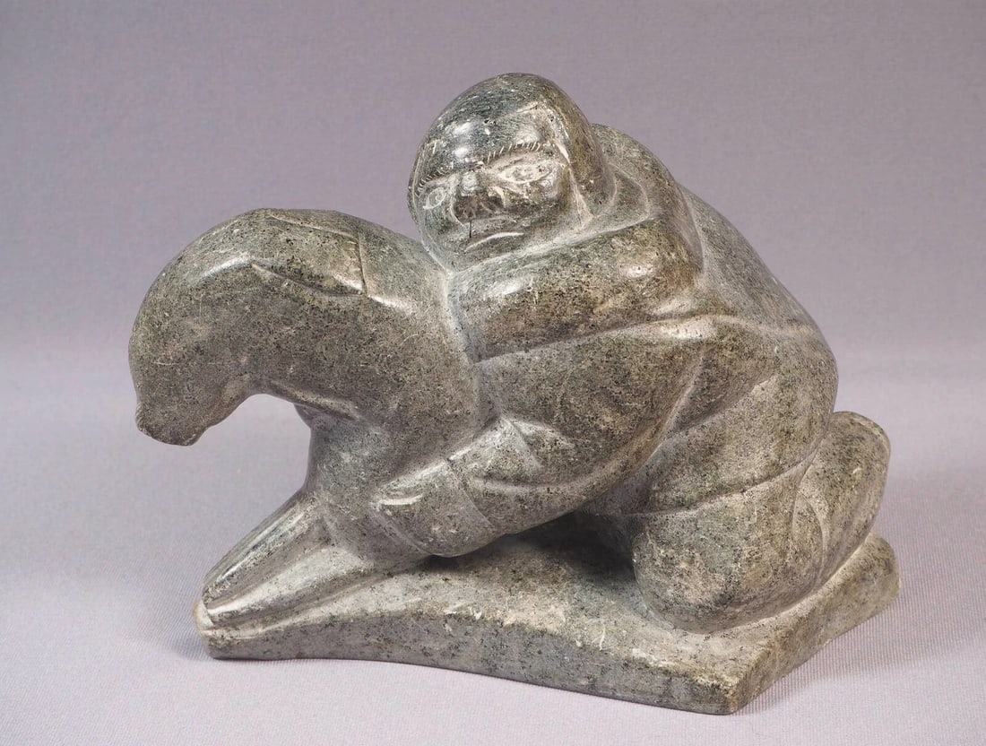 Inuit Eskimo Native American Soapstone Carving Man Seal Markossi Annutak: This is a vintage Primitive Native American Eskimo Figurine. The figurine is made from stone and it is very beautiful. It shows a man in a traditional outfit holding a seal. It is signed at the