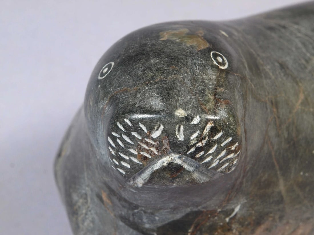 Soapstone Inuit Native Canada Figurine Seal Sea Lion Signed Vintage SIGNED: This is a vintage, Native American Canadian Inuit Figurine. It is signed at the bottom. The figurine shows a seal or sea lion. The carving is app. 8" long and 5" tallIt is in good vintage condition