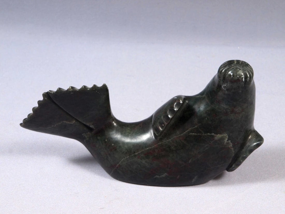 Soapstone Inuit Native Canada Figurine Seal Sea Lion Signed Vintage: This is a vintage, Native American Canadian Inuit Figurine. It is signed at the bottom and have an original Canada Eskimo sticker. The figurine shows a seal or sea lion. The carving is app. 7" long