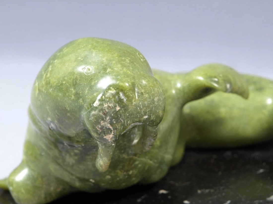 Soapstone Inuit Native Canada Figurine Green Seal Sea Lion on base Vintage: This is a vintage, Native American Canadian Inuit Figurine. The figurine shows a green stone seal or sea lion on a black stone base. The base is 6" and the figure with the base is 4 1/2" tallIt is in