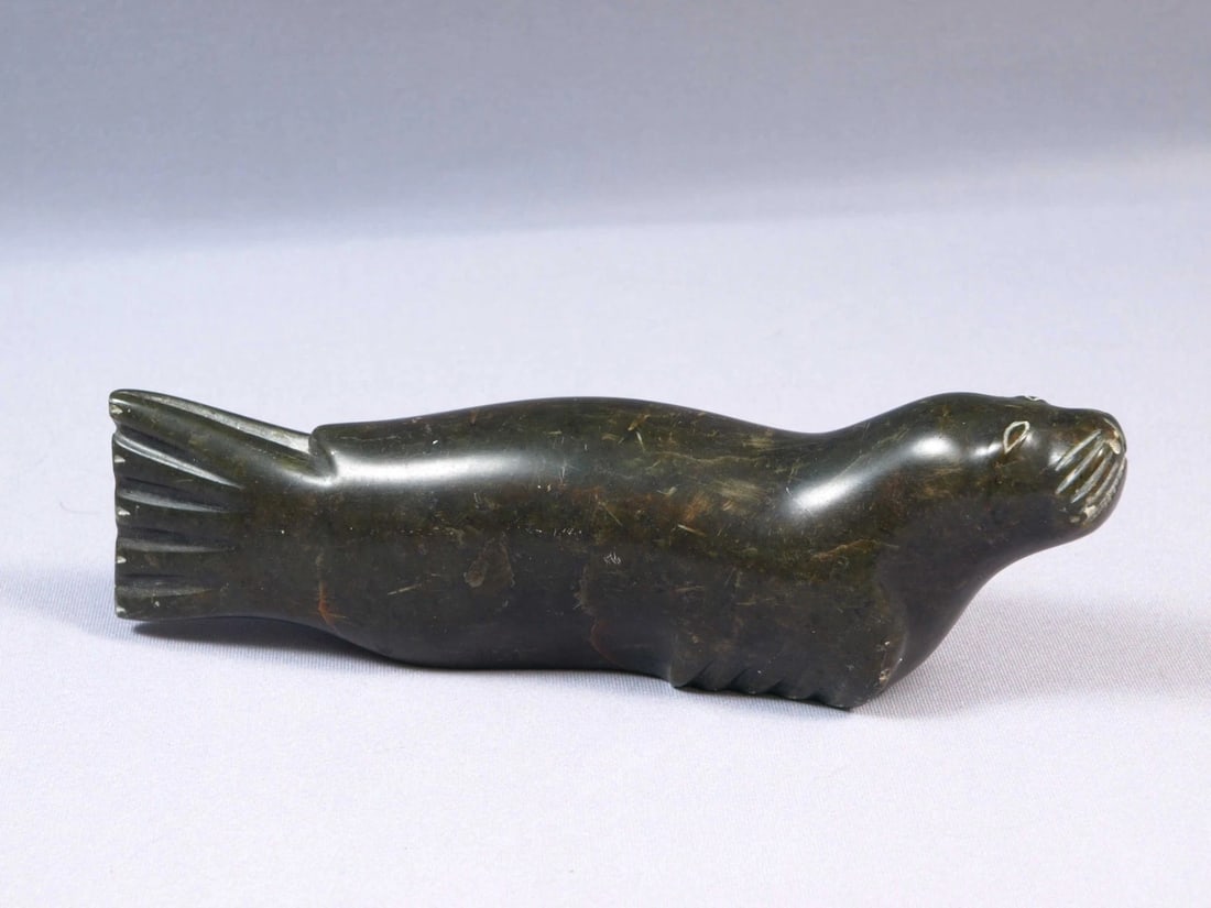 Soapstone Inuit Native Canada Figurine Black Seal Signed Vintage 1971: This is a vintage, Native American Canadian Inuit Figurine. It is signed at the bottom with numbers and some letters. Possibly it was made in 1971 or 1975. It comes with original Canada Eskimo Art