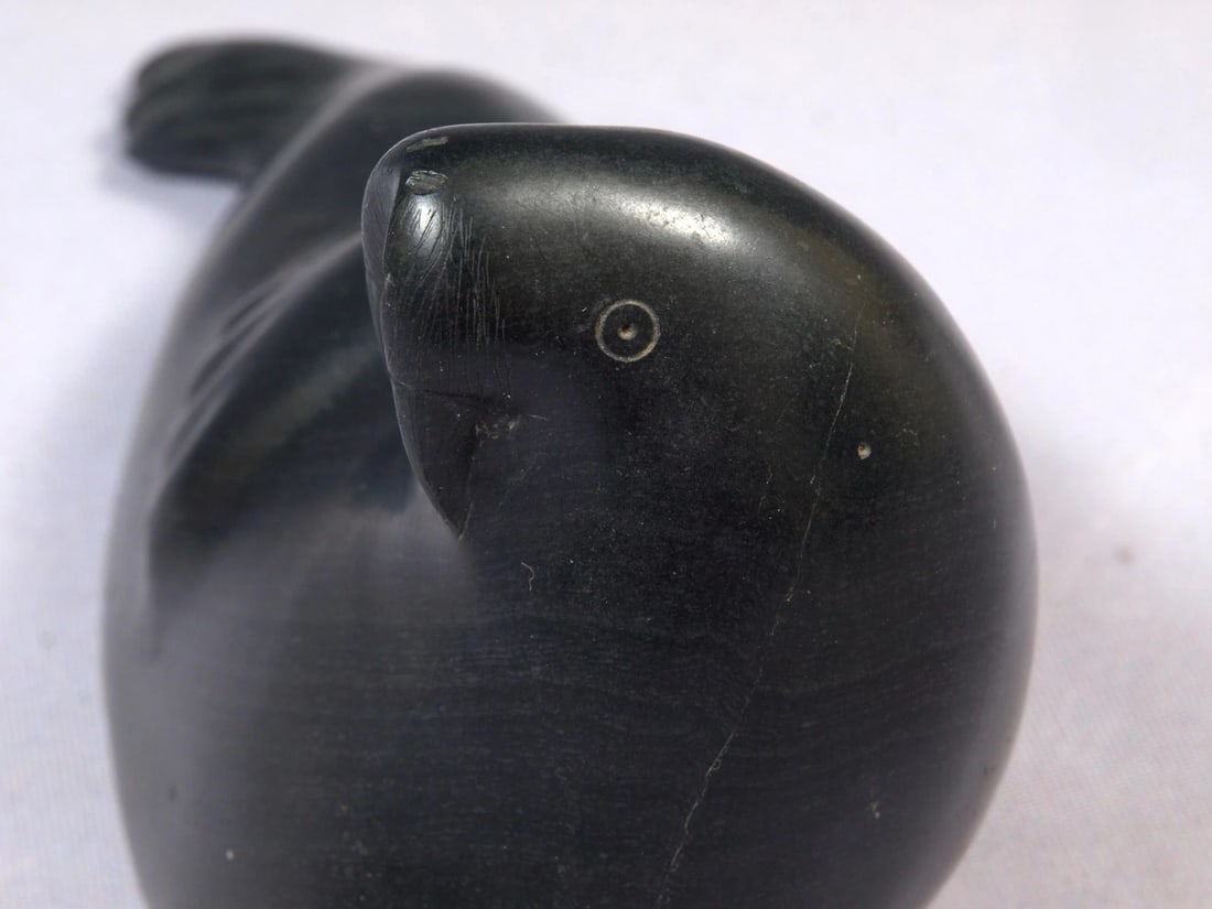 Soapstone Inuit Native Canada Figurine Black Seal Vintage Canada: This is a vintage, Native American Canadian Inuit Figurine. The figurine is made from black soapstone and is very beautiful. The figurine shows a seal. The carving is app. 8 1/2"" long and 4 1/4"
