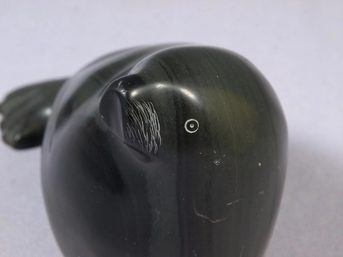 Soapstone Inuit Native Canada Figurine Black Seal Vintage: This is a vintage, Native American Canadian Inuit Figurine. The figurine is made from black soapstone and is very beautiful. The figurine shows a seal. The carving is app. 5" long and 4" tall. It is
