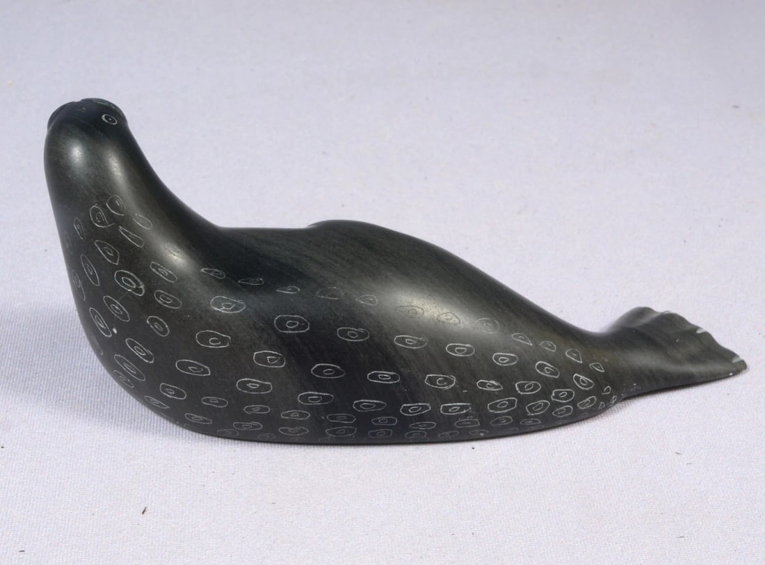 Soapstone Inuit Native Canada Figurine Black Seal Vintage Sticker: This is a vintage, Native American Canadian Inuit Figurine. It looks it is is signed at the bottom under the sticker. It has vintage Canada Eskimo Art Sticker. The figurine is made from black