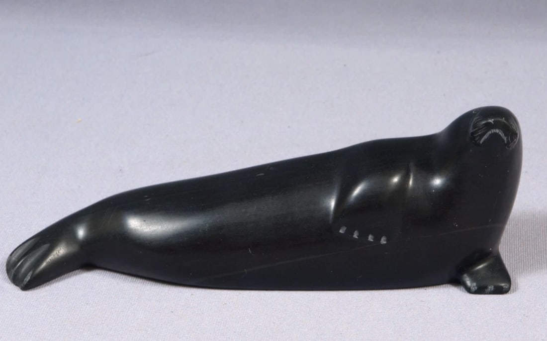 Soapstone Inuit Native Canada Figurine Black Seal Vintage long: This is a vintage, Native American Canadian Inuit Figurine. It looks it is is signed at the bottom. The figurine is made from black soapstone and is very beautiful. The figurine shows a seal. The