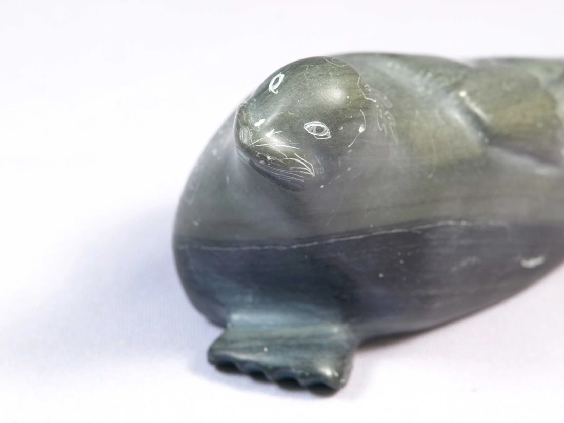 Soapstone Inuit Native Canada Figurine Seal Sea Lion Vintage: This is a vintage, Native American Canadian Inuit Figurine. The figurine is made from soapstone and is very beautiful. The figurine shows a seal or a sea lion. The carving is app. 8" long and 3"