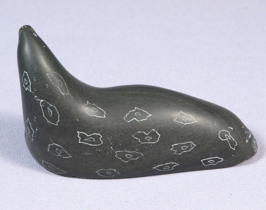 Soapstone Inuit Native Canada Figurine Seal Sea Lion Canada Label SIGNED JS: This is a vintage, Primitive Native American Canadian Inuit Figurine. It is signed with JS at the bottom and has a Canada Eskimo Arts Sticker. The figurine is made from black soapstone and is very bea