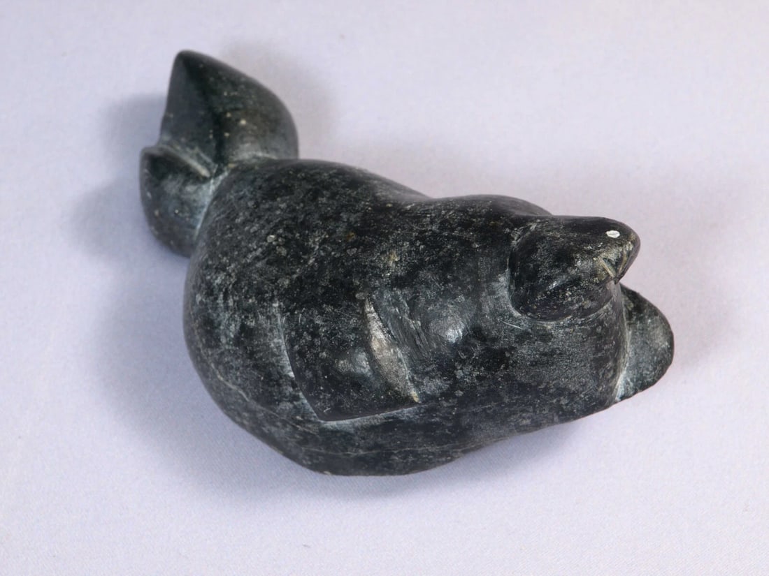 Inuit Canada Native Carving Sea Lion Walrus Soapstone Black: This is a vintage Native American Eskimo Inuit FigurineIt is signed on the bottom with some numbers The figurine is made from stone. I think it is a large sea lion or walrus but I am not very sure.